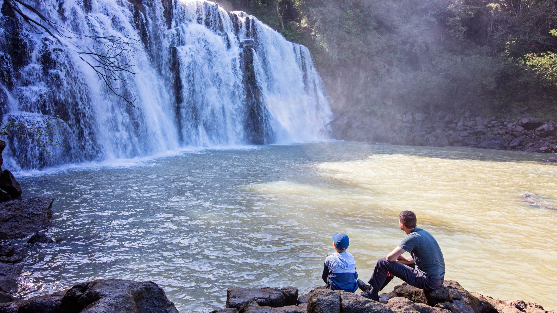 Family hiking to waterfall in Northern California.